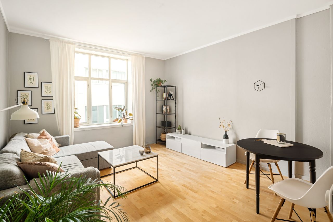 A contemporary Scandinavian living room with minimalist furniture and decor.